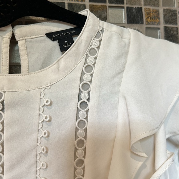 White with short ruffle sleeve and see through detail down the front. - Picture 2 of 2